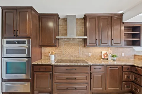 a kitchen with granite countertop stainless steel appliances and cabinets