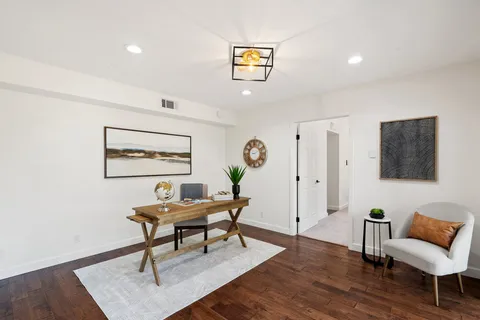 a living room with furniture and a potted plant