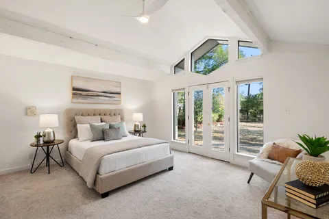 a bedroom with a large bed and a window