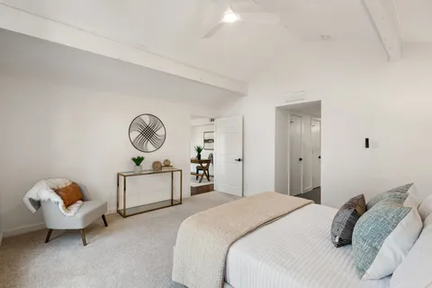 a bedroom with bed and windows