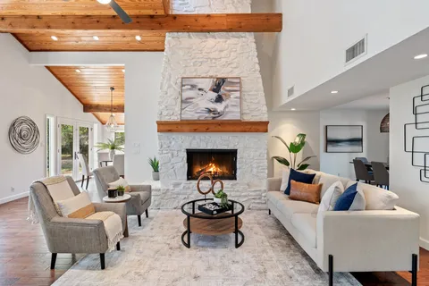 a living room with furniture a fireplace and a table