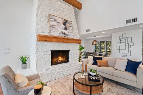 a living room with furniture and a fireplace