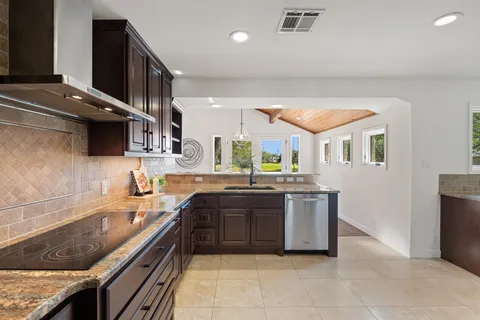 a large kitchen with a stove and a sink
