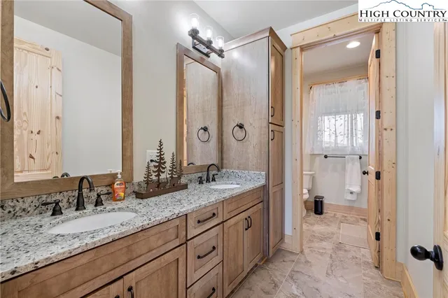 a spacious bathroom with a granite countertop sink mirror and shower