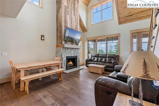 a living room with furniture a fireplace and a large window