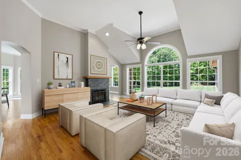 a living room with furniture and a chandelier