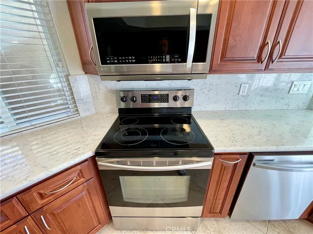 a stove top oven sitting inside of a kitchen