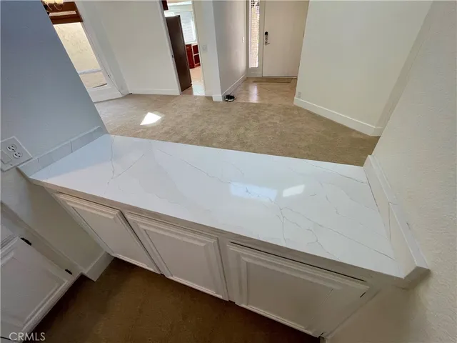 a bathroom with a granite countertop double vanity sink and mirror