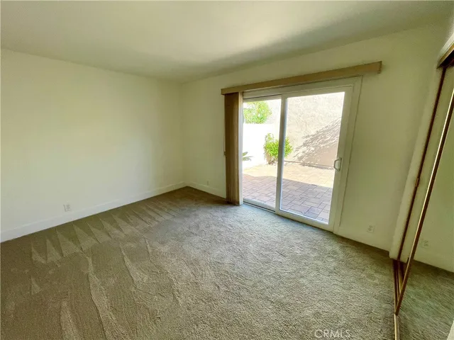 an empty room with an entrance to other room