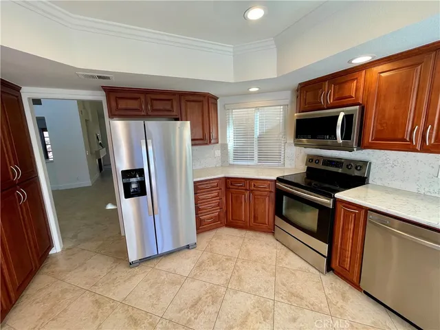 a kitchen with stainless steel appliances granite countertop a refrigerator and a sink