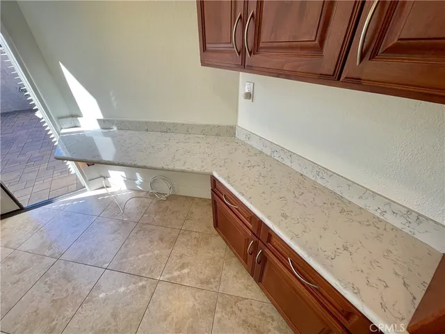 a view of kitchen cabinets and window