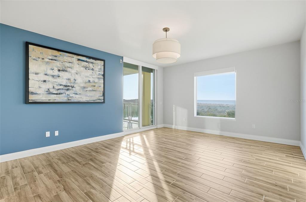 800 Collany Road, Unit 302 St. Petersburg, FL 33715 - Photo 51 of 66 a view of an empty room with wooden floor and a window