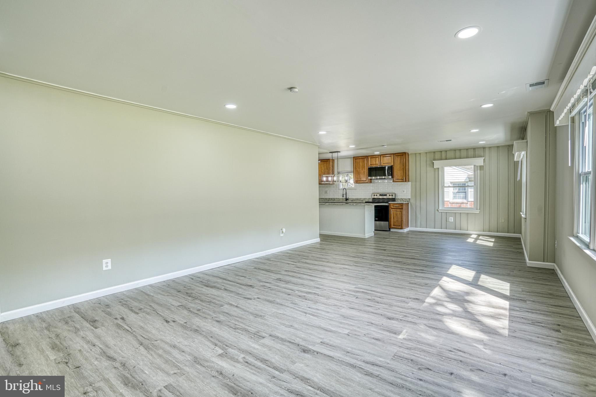 607 Edlon Park Cambridge, MD 21613 - Photo 11 of 34 an empty room with wooden floor and fireplace