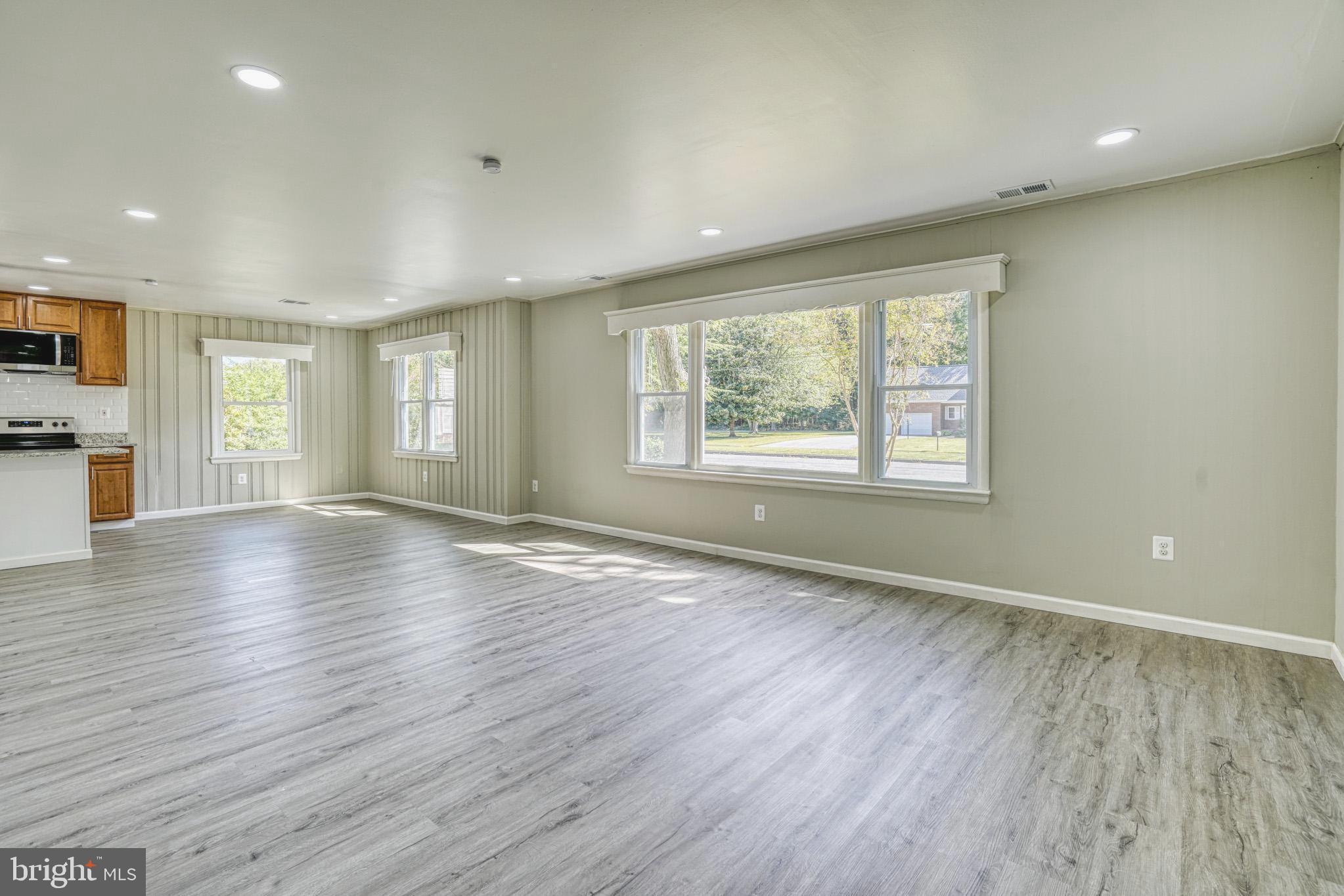 607 Edlon Park Cambridge, MD 21613 - Photo 12 of 34 an empty room with wooden floor and windows