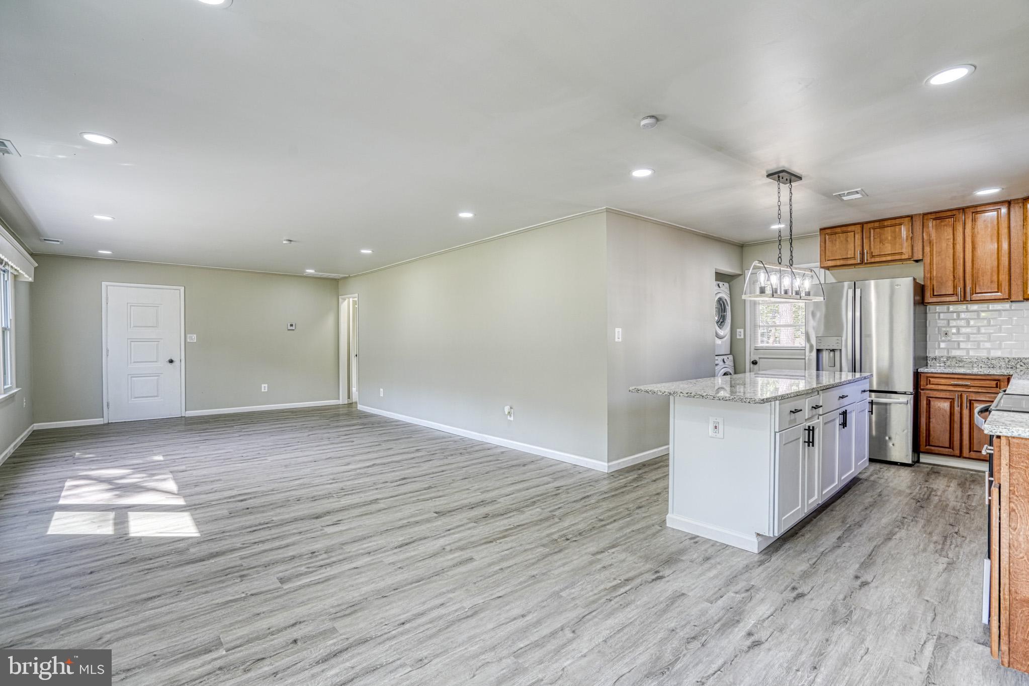 607 Edlon Park Cambridge, MD 21613 - Photo 14 of 34 a large kitchen with granite countertop a large counter top and stainless steel appliances