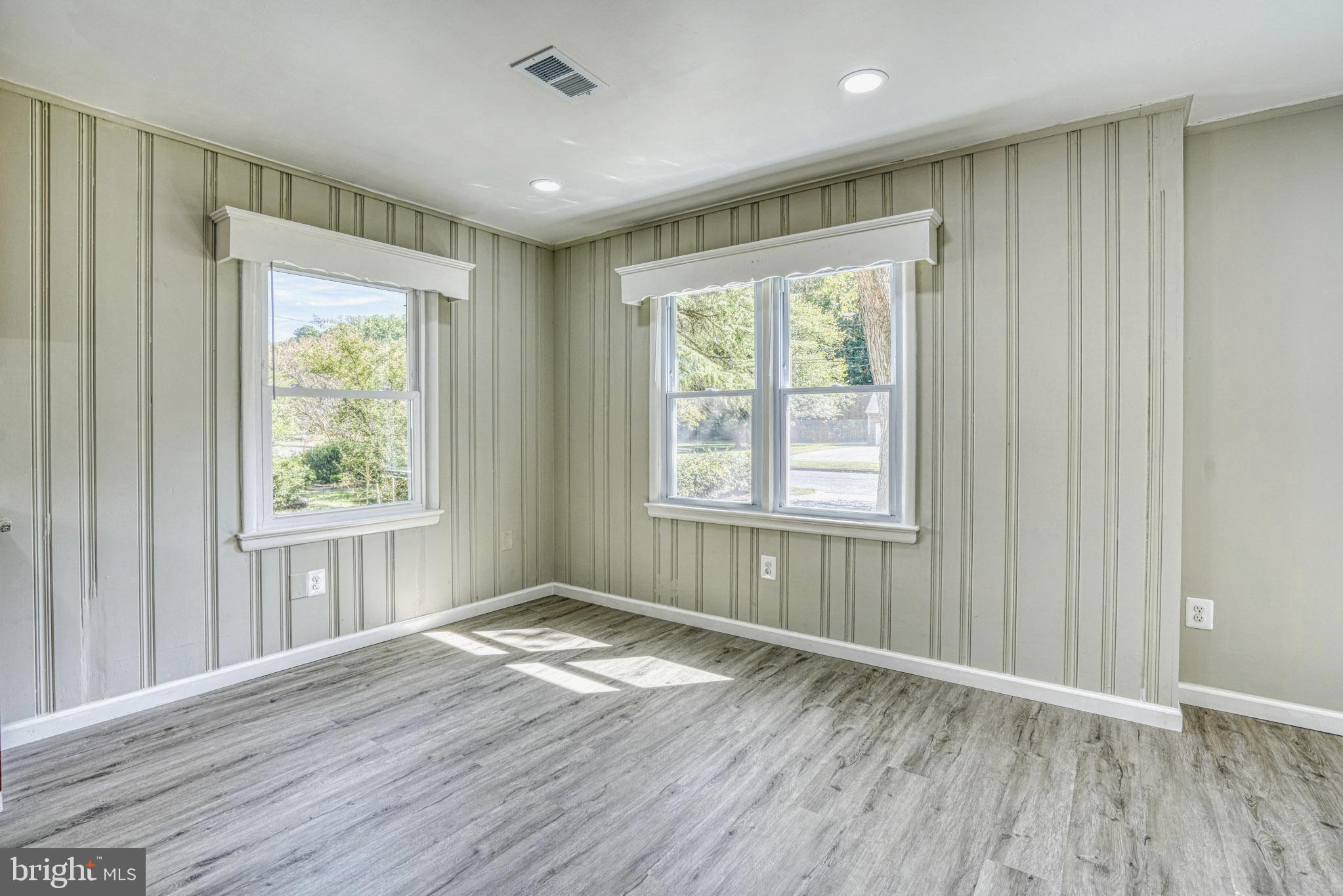 607 Edlon Park Cambridge, MD 21613 - Photo 19 of 34 a view of an empty room with wooden floor and a window