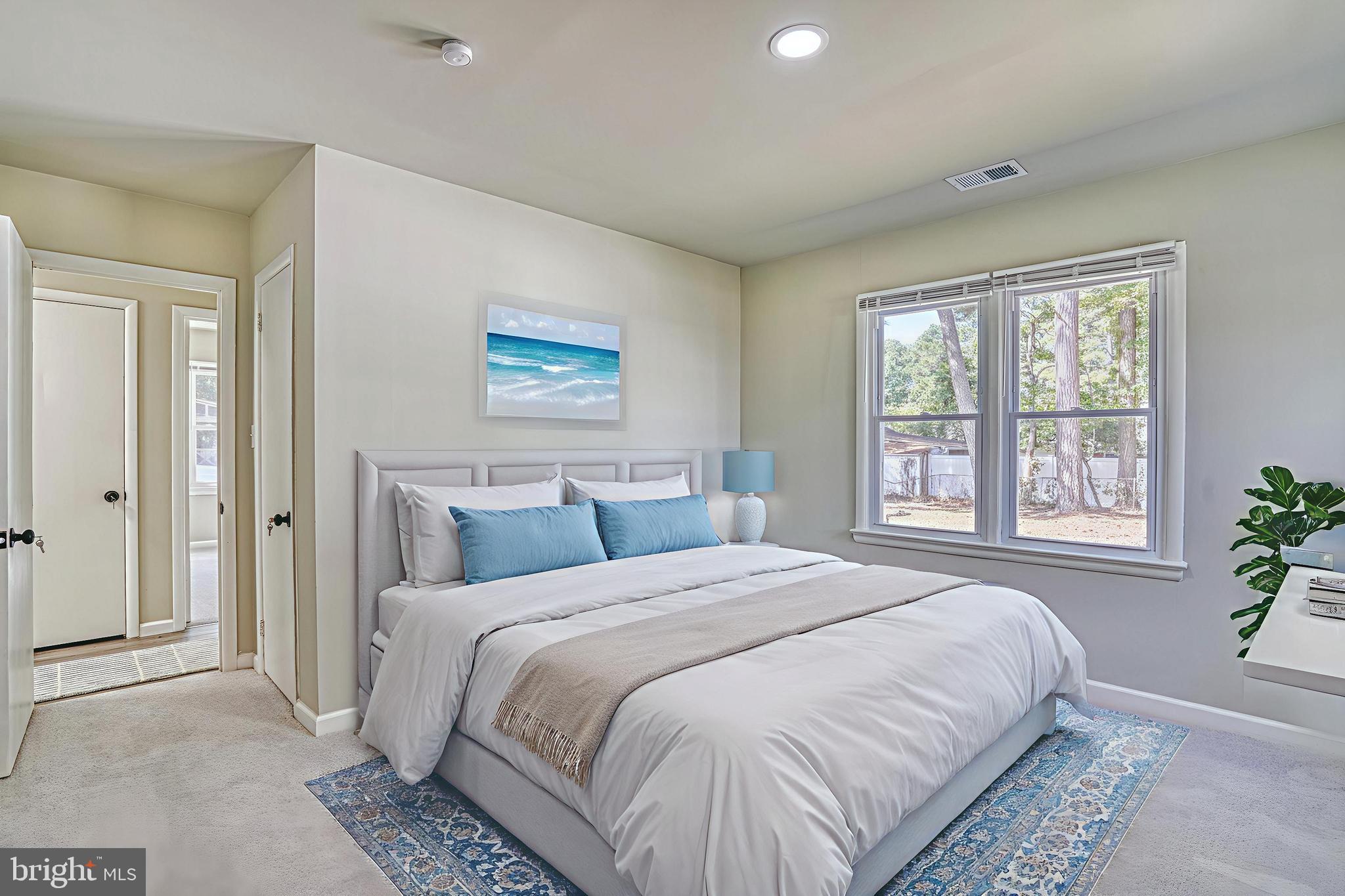 607 Edlon Park Cambridge, MD 21613 - Photo 22 of 34 a bedroom with a bed and a large window