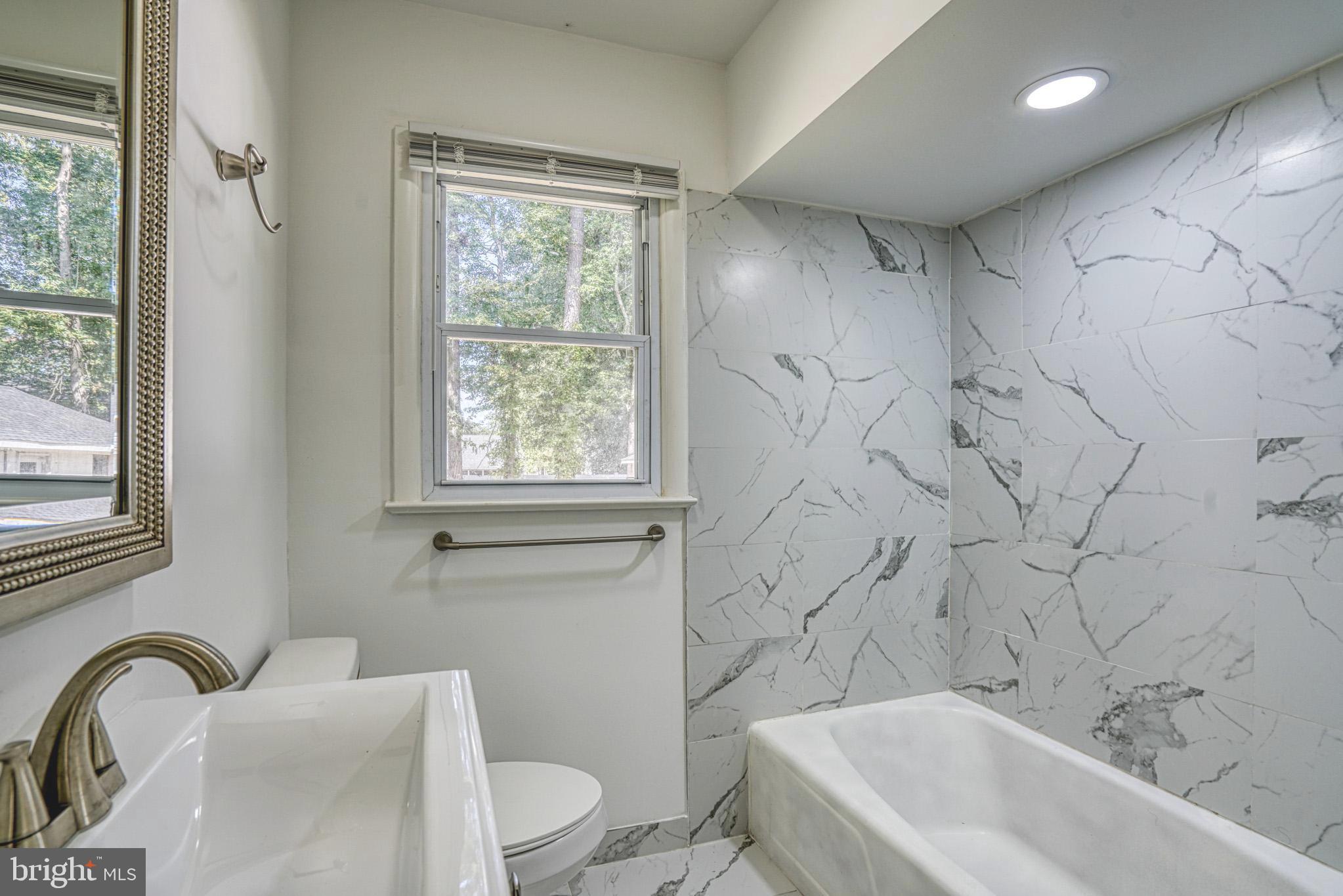 607 Edlon Park Cambridge, MD 21613 - Photo 34 of 34 a bathroom with a toilet sink and bathtub