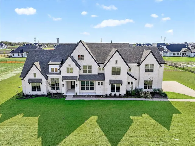a view of a house with a big yard and potted plants