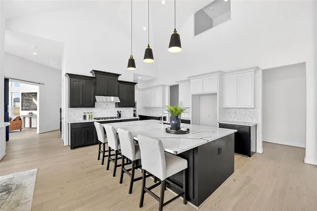 a view of kitchen with cabinets table and chairs