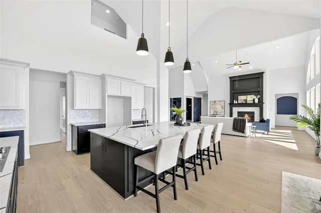 a large kitchen with a table and chairs