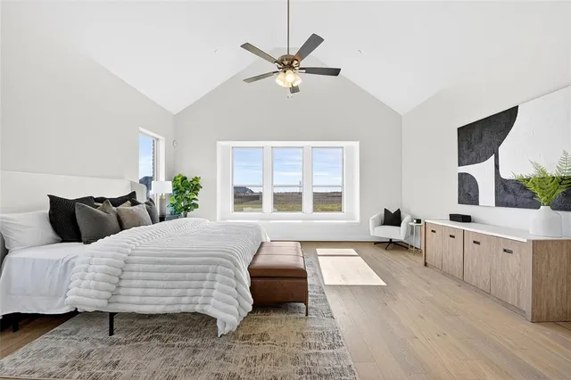 a bedroom with a large bed and a large window