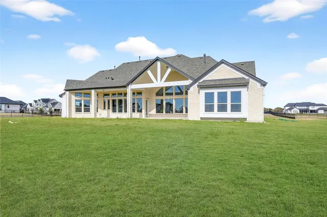 a front view of a house with a garden and yard