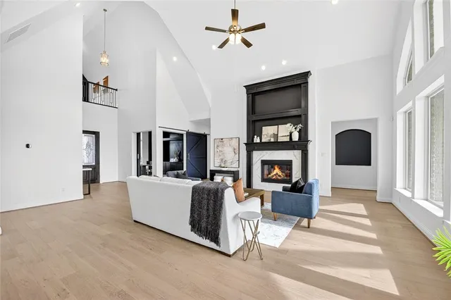 a living room with fireplace furniture and a window