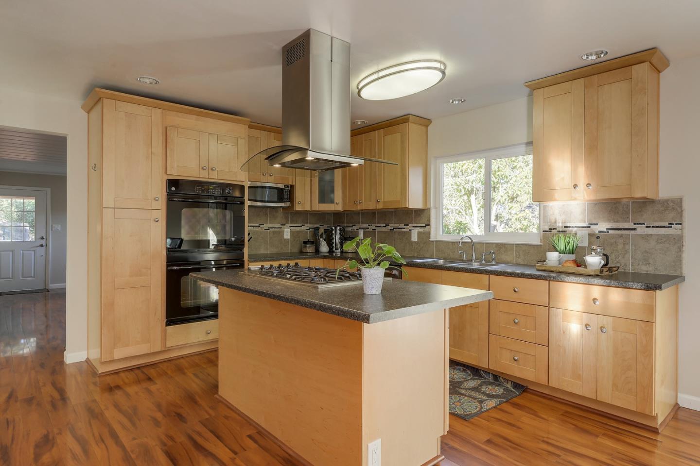 22620 Ricardo Road Cupertino, CA 95014 - Photo 11 of 34 a kitchen with stainless steel appliances granite countertop a sink a stove and a refrigerator