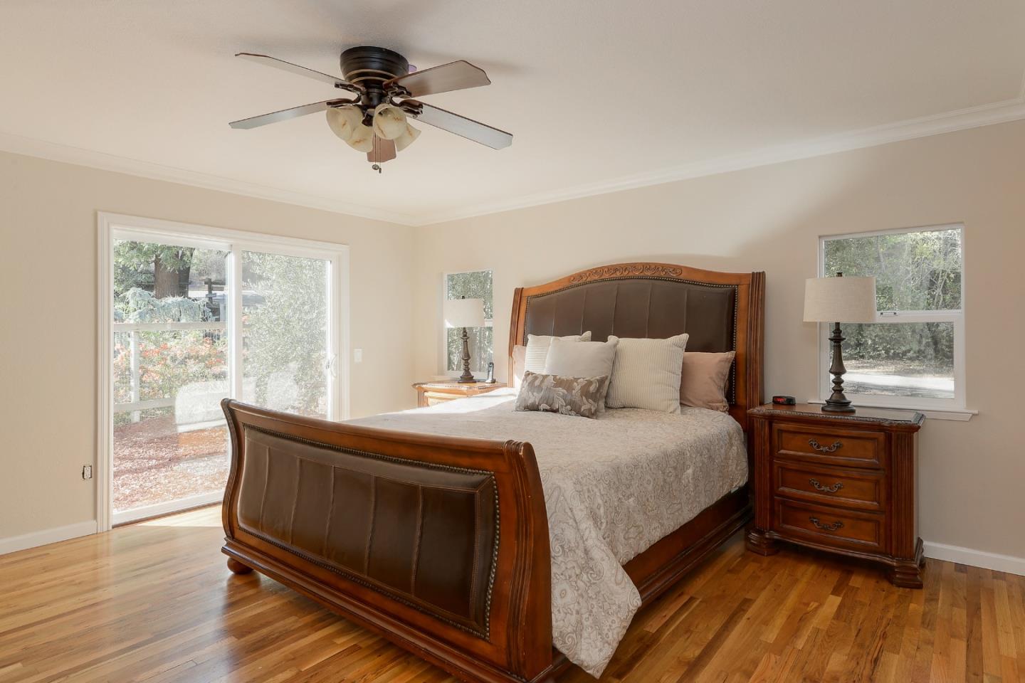 22620 Ricardo Road Cupertino, CA 95014 - Photo 13 of 34 a bedroom with a bed and a chandelier