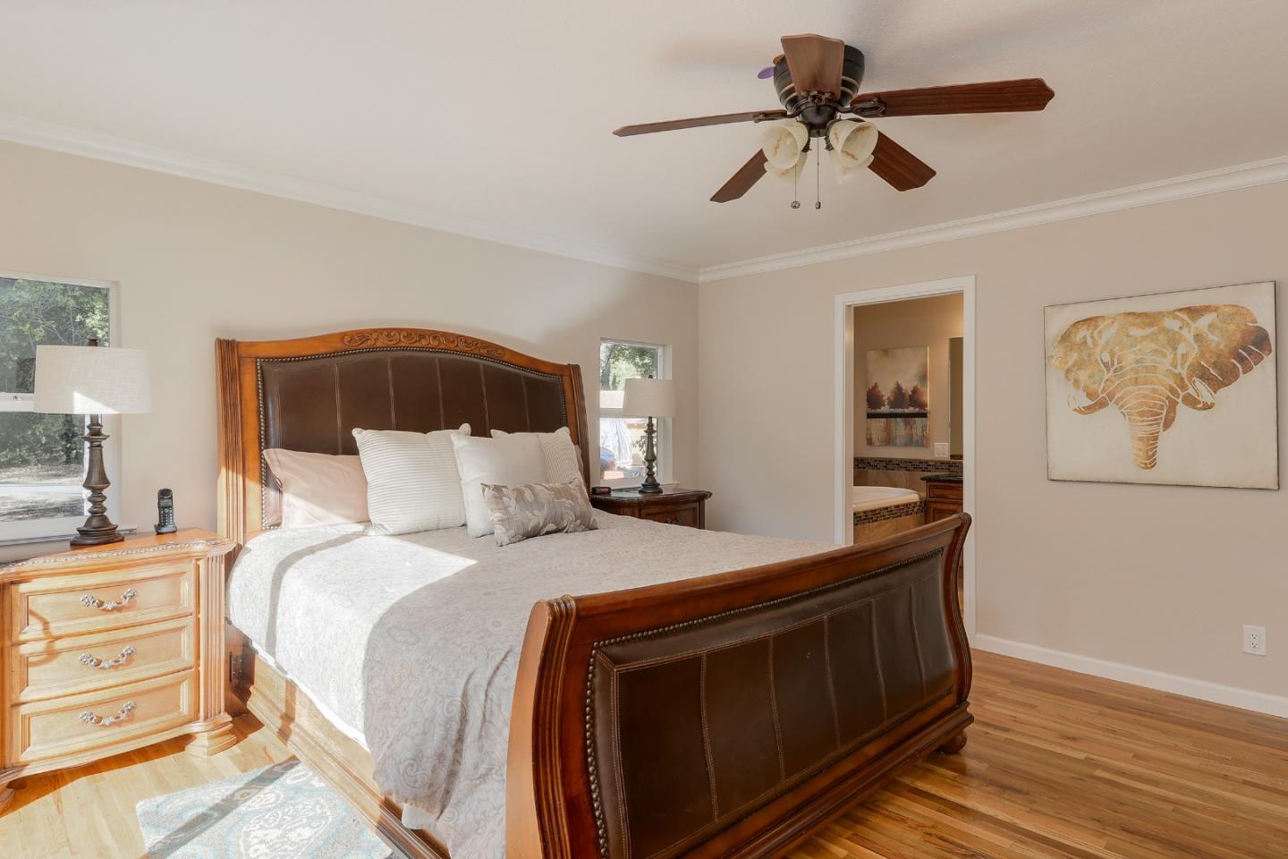 22620 Ricardo Road Cupertino, CA 95014 - Photo 14 of 34 a bedroom with a bed and a chandelier