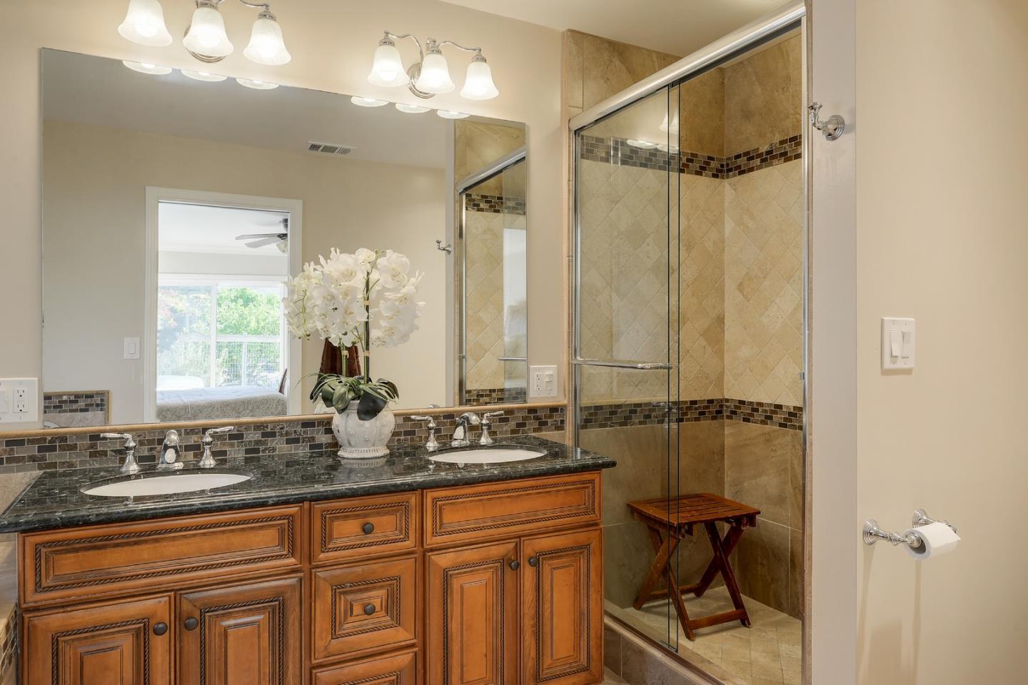 22620 Ricardo Road Cupertino, CA 95014 - Photo 16 of 34 a bathroom with a double vanity sink a mirror and a shower