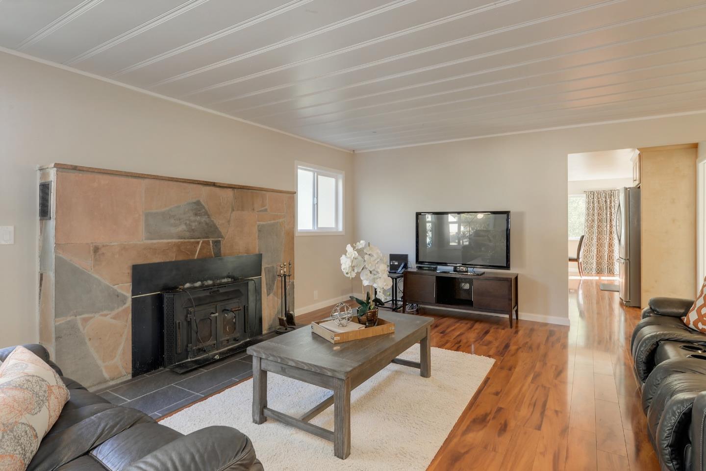 22620 Ricardo Road Cupertino, CA 95014 - Photo 3 of 34 a living room with furniture and a flat screen tv