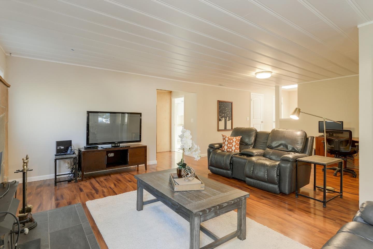 22620 Ricardo Road Cupertino, CA 95014 - Photo 4 of 34 a living room with furniture and a flat screen tv