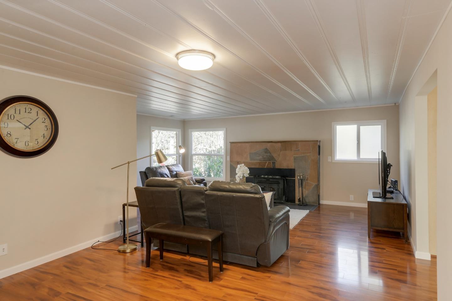 22620 Ricardo Road Cupertino, CA 95014 - Photo 6 of 34 a living room with furniture a fireplace and wooden floor