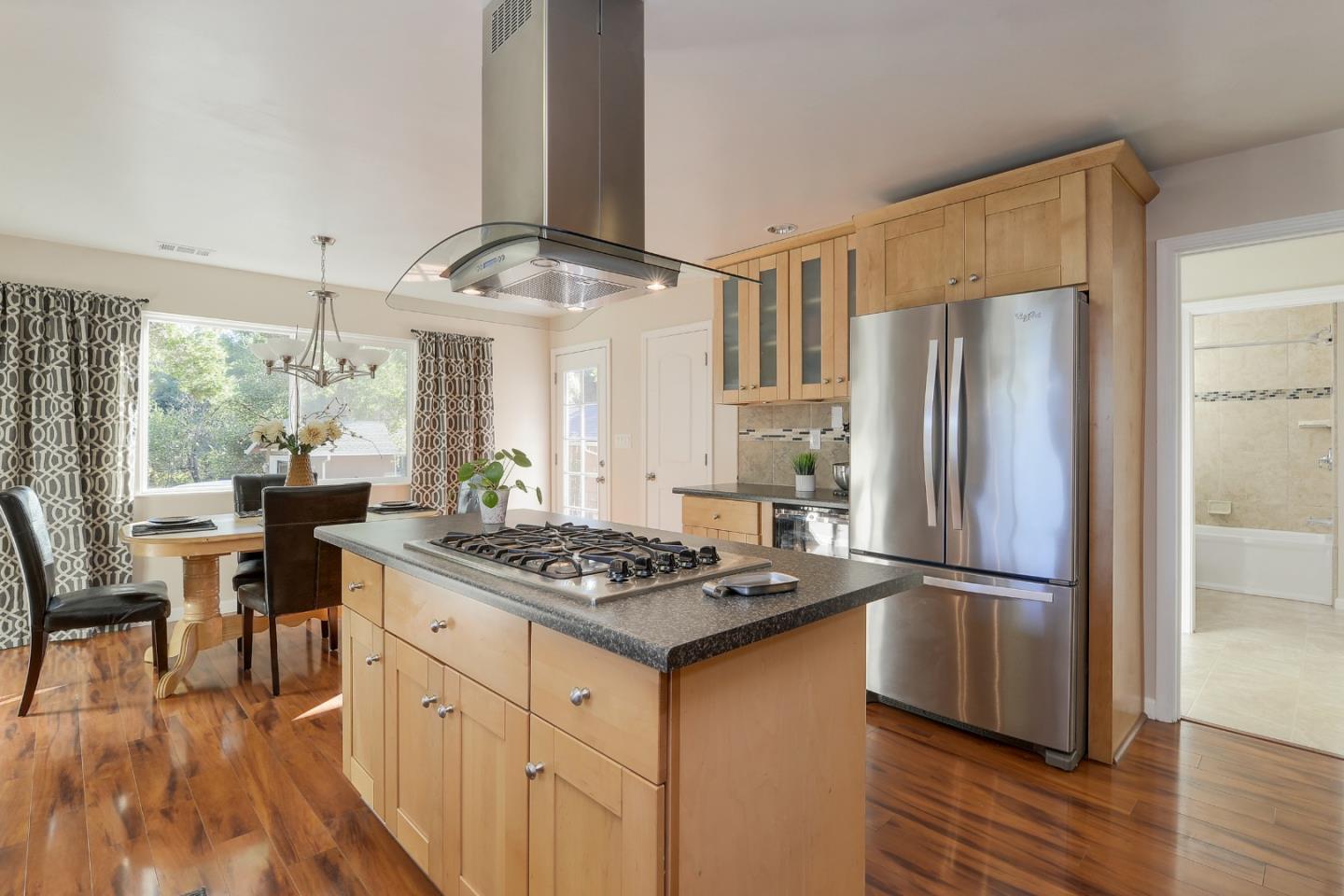 22620 Ricardo Road Cupertino, CA 95014 - Photo 10 of 34 a kitchen with stainless steel appliances granite countertop a refrigerator a stove and a wooden floors