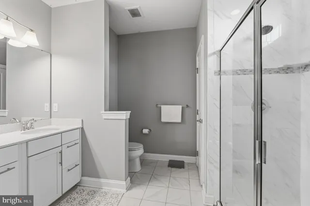 a bathroom with a toilet sink and a mirror