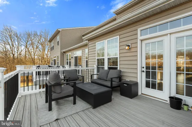 a balcony with furniture and wooden floor