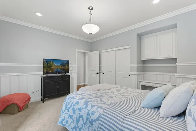 a bedroom with a bed and dresser