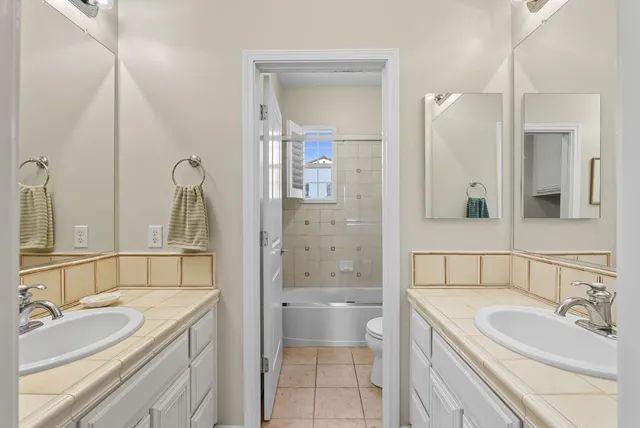 a bathroom with a tub sink and mirror