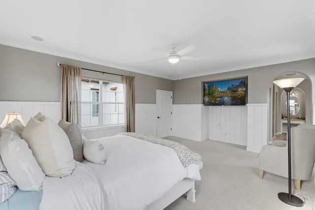 a bedroom with a large bed and a window