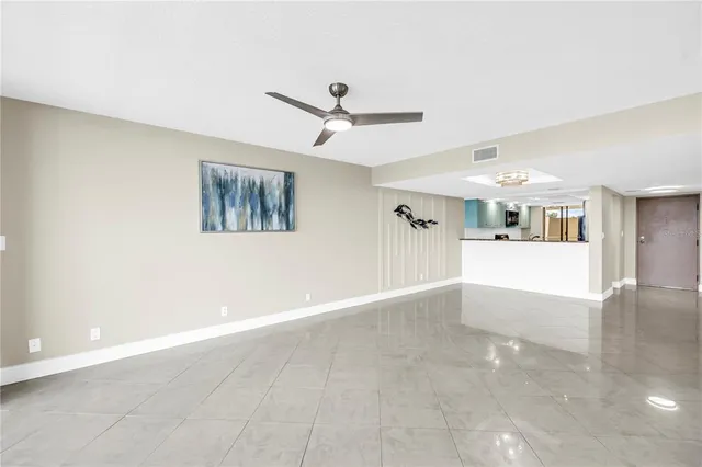 a view of a livingroom with wooden floor and a ceiling fan