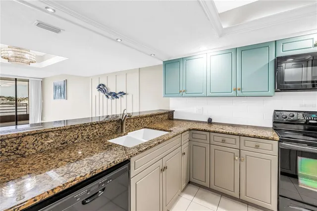 a kitchen with a refrigerator and a stove top oven