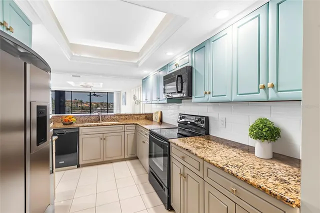 a kitchen with stainless steel appliances granite countertop a stove and a sink