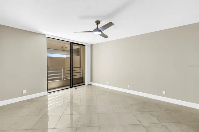 a view of a livingroom with a ceiling fan & entryway