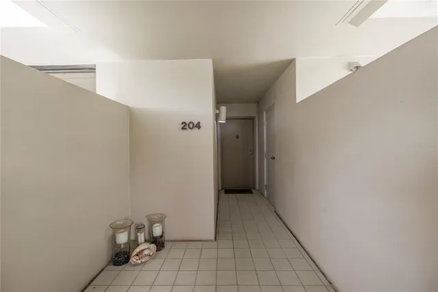 a view of a hallway with living room and dining room