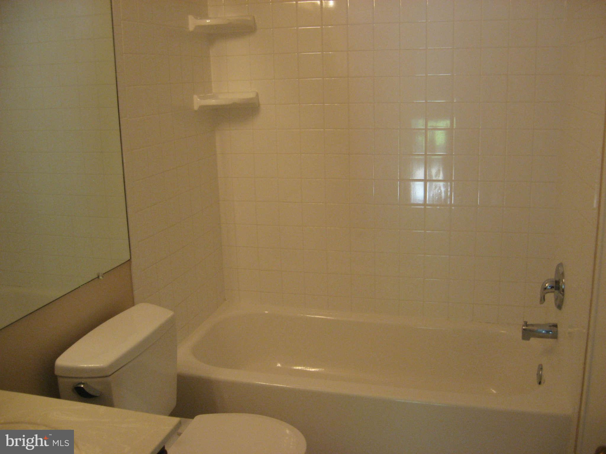 2356 Hunters Square Court, Unit 2356 Reston, VA 20191 - Photo 16 of 27 a bathroom with a toilet and bathtub