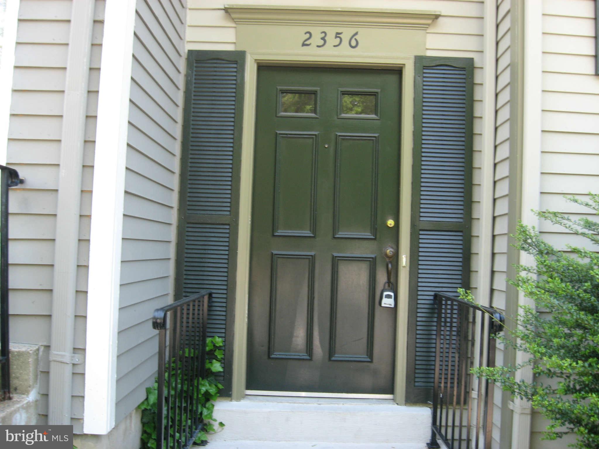 2356 Hunters Square Court, Unit 2356 Reston, VA 20191 - Photo 3 of 27 a front view of a house with a glass door