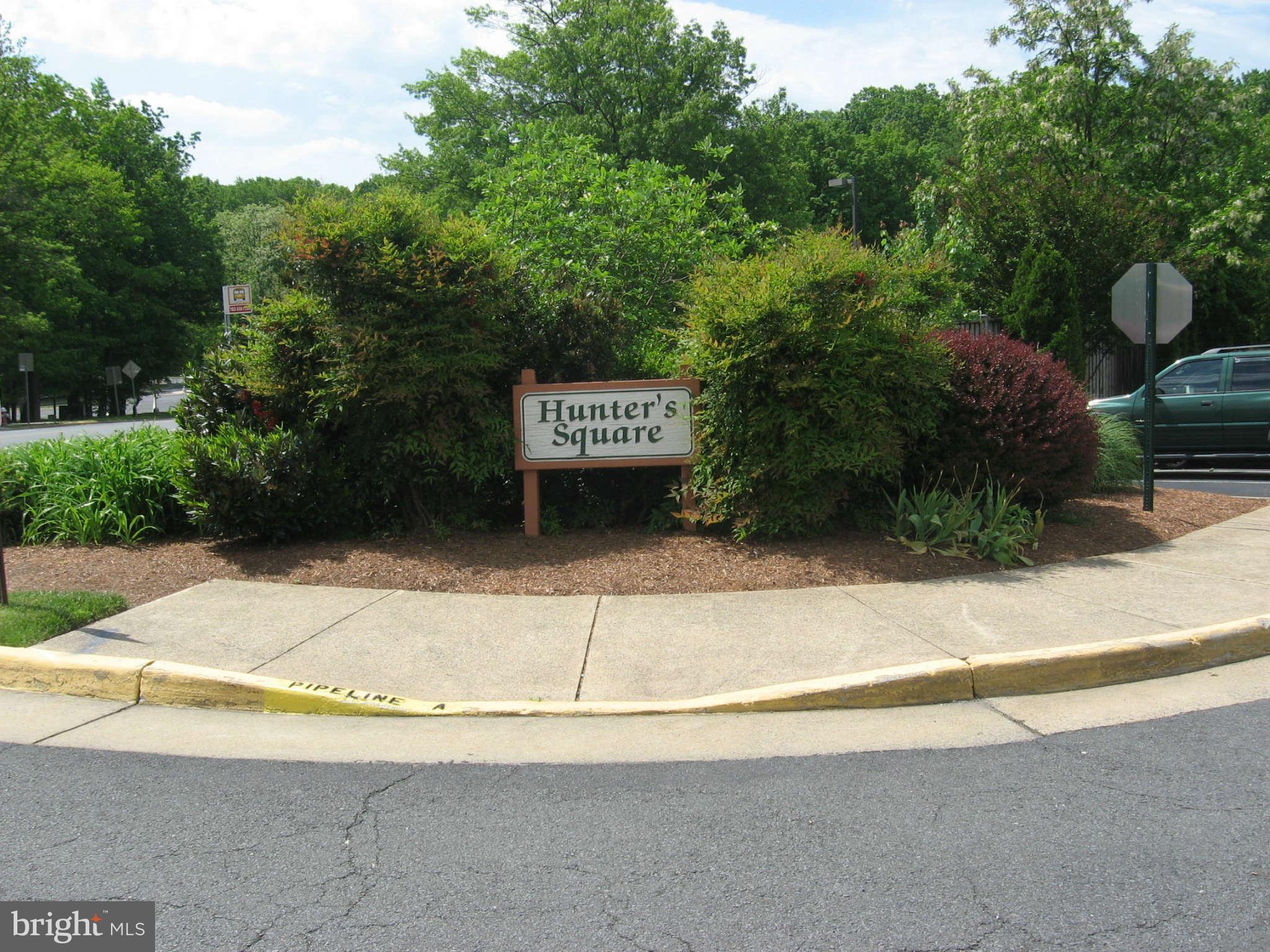 2356 Hunters Square Court, Unit 2356 Reston, VA 20191 - Photo 26 of 27 a view of a street with potted plants and large trees