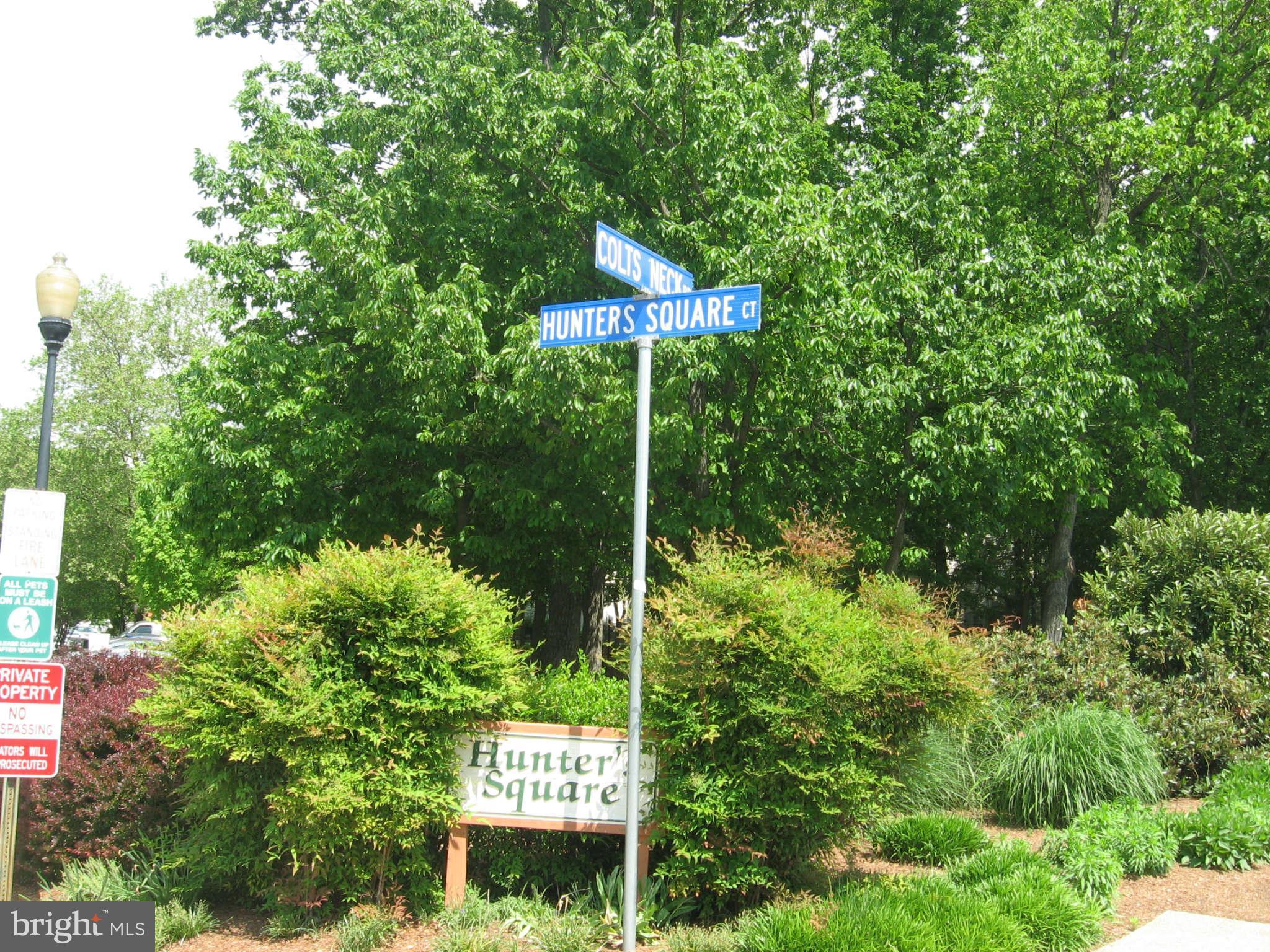 2356 Hunters Square Court, Unit 2356 Reston, VA 20191 - Photo 27 of 27 a sign that is sitting in front of a tree